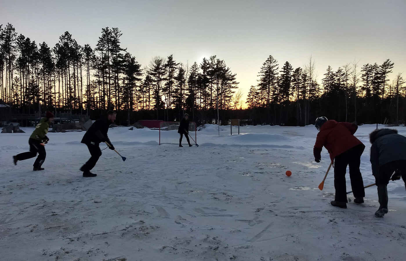 Students playing hockey outside