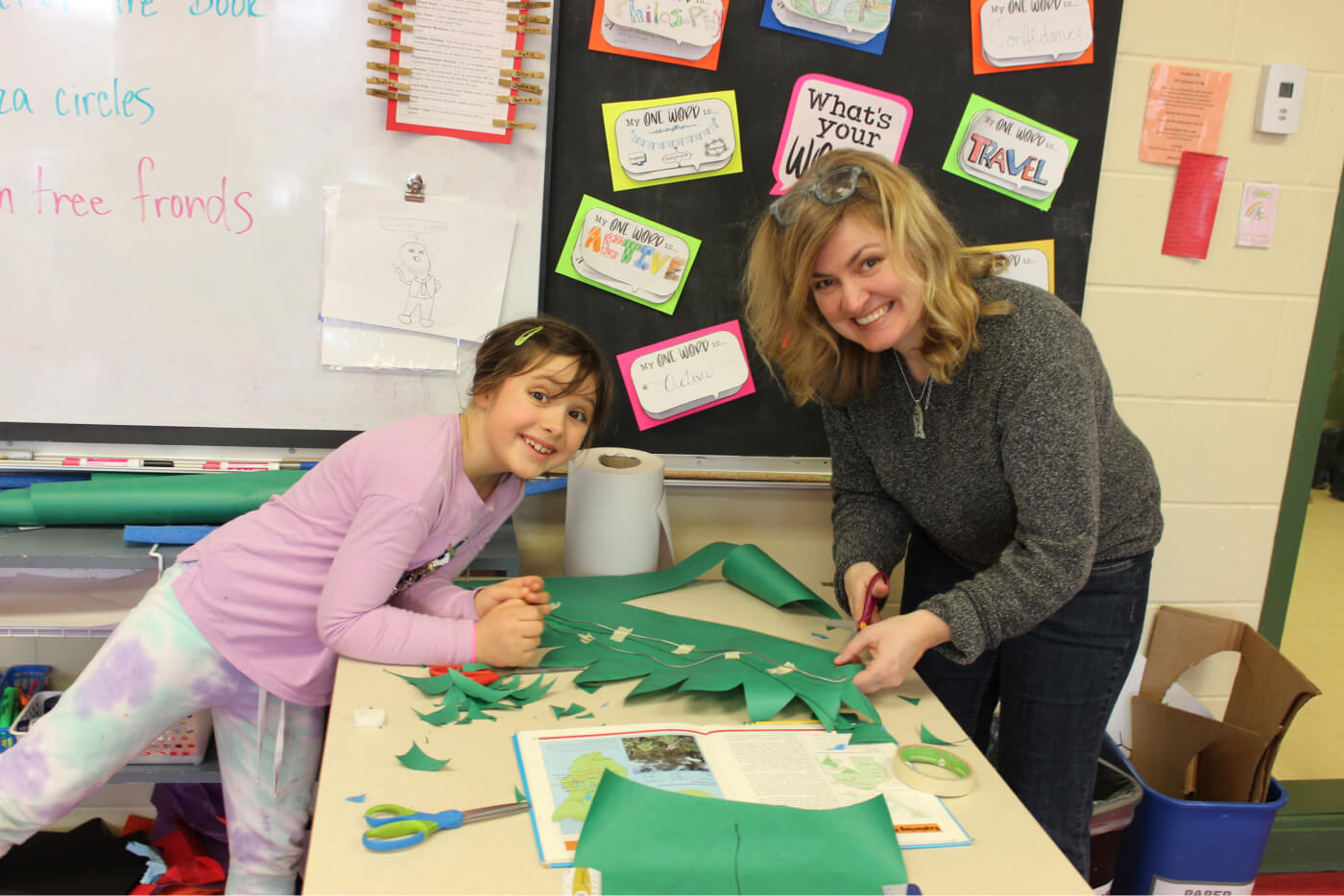 Adult helping a child making decorations