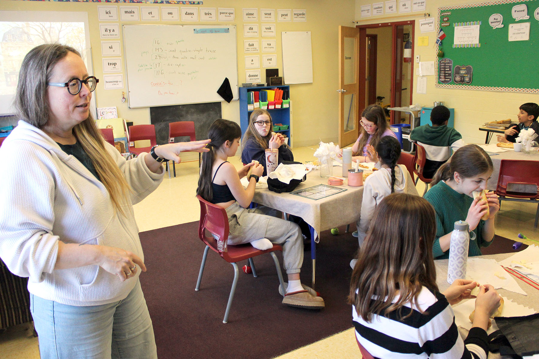 The French Language Club host introduces the featured treat to students.